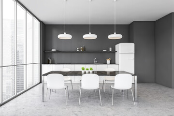 Grey and white kitchen set with fridge, chairs and dining table near window