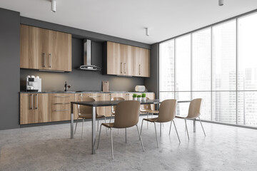Modern gray kitchen corner with table and window