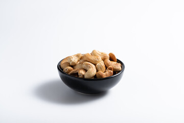 Cashew nut in container with white background