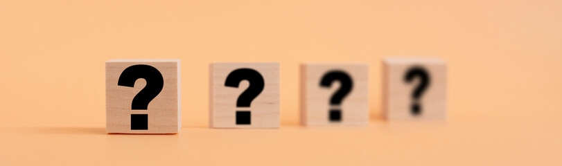 Wooden cube block shape with sign question mark symbol. FAQ frequency asked questions, Answer,...