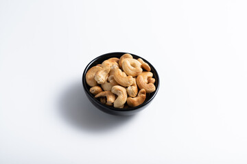 Cashew nut in container with white background