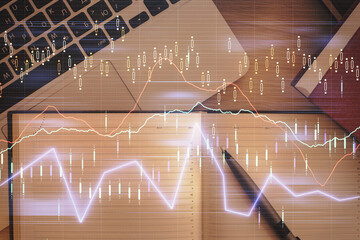 Stock market chart and top view computer on the table background. Double exposure. Concept of financial analysis.