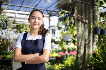 Portrait of confident Caucasian young owner woman gardener crossing hand at workplace in...