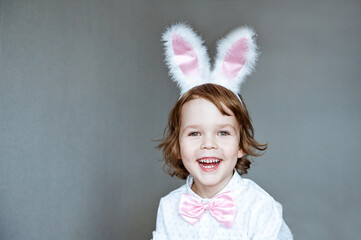 Cute little child wearing bunny ears on Easter day.