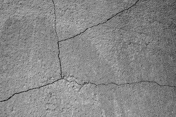 Big winding ramified crack on an old concrete wall. Crack divides the wall into four parts....