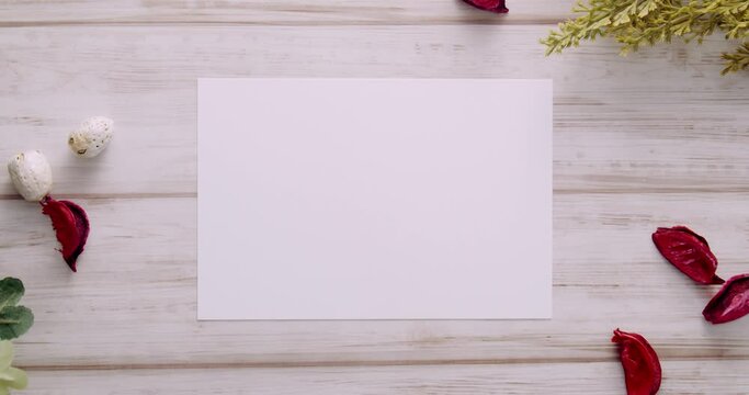 Feminine desktop mockup with blank white paper card, branches and red colour Pot Pourri on white shabby table background. For web banner. Stylish flat lay, top view, slow dynamic zoom, minimal