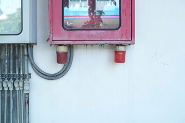 A suite of a fire equipment electric control on a wall fence. 