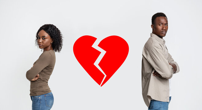 Disappointed black man and woman with broken heart between them