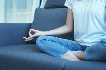 yogi woman practicing yoga lesson, breathing, meditating, indoor close up. Well being, wellness concept