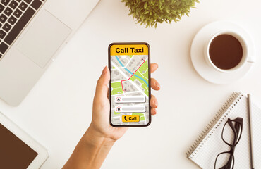 Above view of woman holding smartphone with taxi app interface