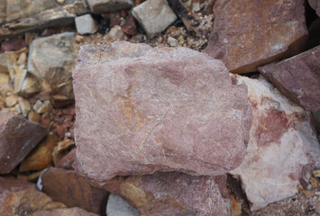 Piece of Pink Arkose Sandstone rock on nature background.  Sandstones are sedimentary rocks. 