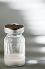 vaccine in glass vial with aluminum cap, refrigerator bottom