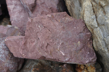 piece of Pink Arkose Sandstone rock on nature background. 
Sandstones are sedimentary rocks. 