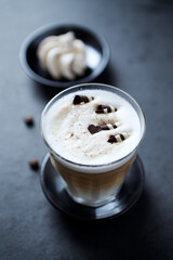  Coffee with milk on dark stone background. Close up.