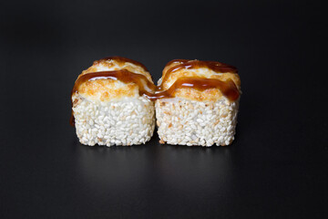 Sushi rolls with sesame seeds on a stone Board for sushi
