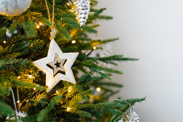Decorated Christmas tree on blurred, sparkling and fairy background