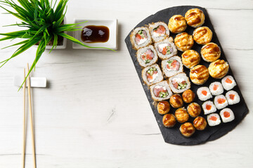 Sushi rolls set on a stone Board for sushi on a light background