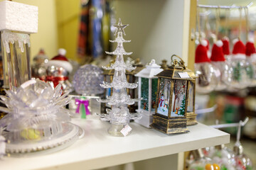 Christmas decoration in the form of a glass Christmas tree on the background of other decorations