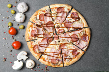 Pizza with barbecue sauce and ingredients on a stone table topview