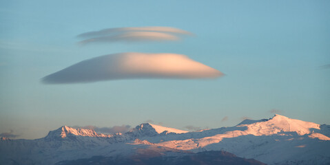 Large white lenticular clouds over Sierra Nevada (Spain) at sunset
