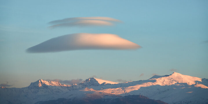Large white lenticular clouds over Sierra Nevada (Spain) at sunset