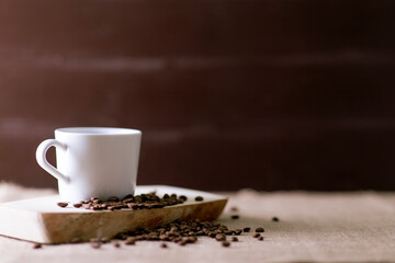 Elegant view of a mug, coffee beans . Copy space includes, vintage looking in brown tones.