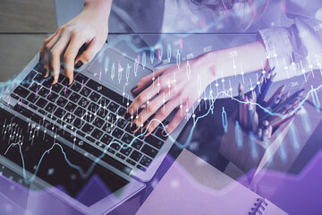 Double exposure of woman hands typing on computer and forex chart hologram drawing. Stock market invest concept.