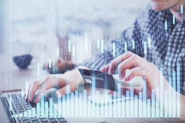Double exposure of man hands holding a credit card and Forex graph drawing. Stock trading and digital fintech in Internet E-commerce concept.