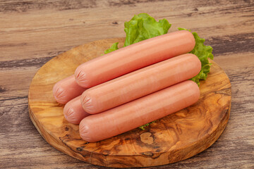 Tasty meat sausages over board