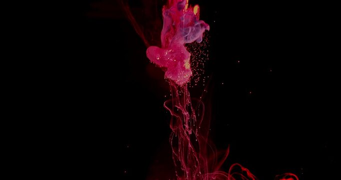Fiery pink and purple ink flows like lava through water on black, abstract
