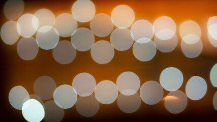 Abstract evening night shimmering bokeh background effect street outside near cafe restaurant. Defocused urban city life blur golden light bulbs garlands. Christmas New Year party holiday concept. 