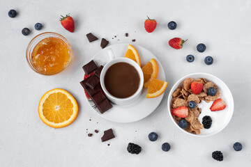 Fruit layout with yogurt and coffee on a white background