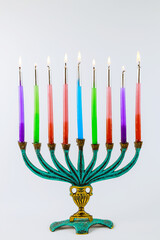 Jewish holiday Hanukkah with hanukkiah menorah on nine candles