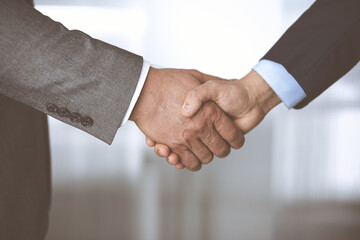 Business people shaking hands finishing contract signing, close-up. Business communication concept. Handshake and marketing