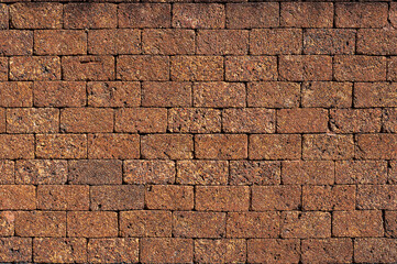 Laterite Stone wall surface red stone brick blocks close up background