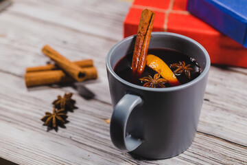 Cup of mulled wine and gift box. Christmas and New Year background concept.