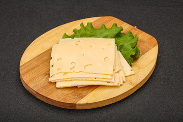 Sliced yellow cheese over board