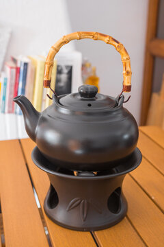 Professional clay kettle used with a alcohol burner. Beautiful object used for Gong Fu Cha brewing in Asia (China, Taiwan...). Vertical shot.