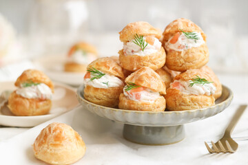 A traditional French savory choux dough cheese puff filled with fresh cheese mixed with smoked...