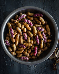 close up of boiled peanuts or groundnuts, macro shot of peanuts in a steel bowl on dark background. agriculture, farming, sustainable, crop, gardening, supplies concepts.