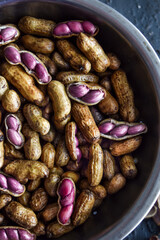 Boiled peanuts or groundnuts, macro shot of peanuts, some shelled with pink groundnuts visible. agriculture, farming, sustainable, crop, gardening, supplies concepts.