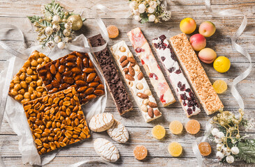 Italian Christmas sweets as different nougats with almonds, nuts, peanuts, candied fruits, marzipan background. Traditional Italian Christmas sweets.