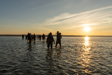 Norddorf, Germany - October 16, 2020: Walking through the sea from Amrum to Föhr during sunrise