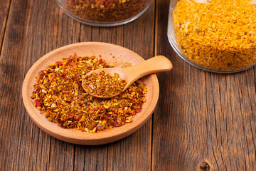 Spices on a wooden table. Spice for cooking. Spice mix in a plate close-up.
