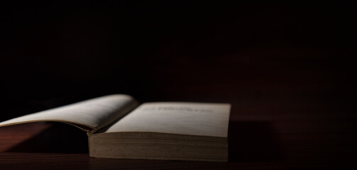 old book in dark isolated background