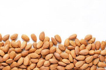 Dry almond seeds on white background with copy space for adding text