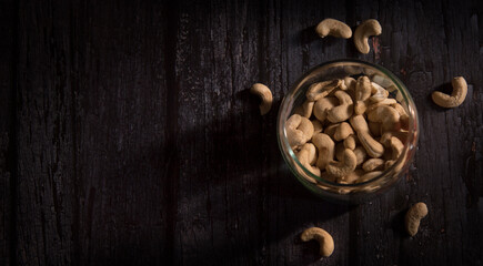 cashew nuts in bowl on dark wooden table