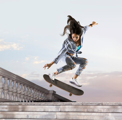 Skateboarder doing a jumping trick - obrazy, fototapety, plakaty