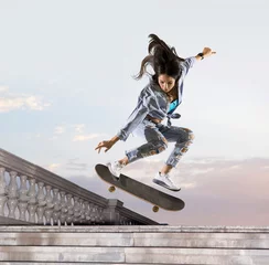Zelfklevend Fotobehang Skateboarder doing a jumping trick © Andrey Burmakin