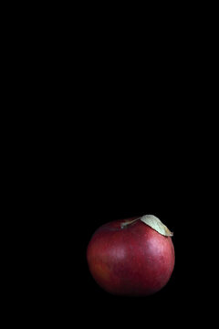 red apple isolated on black background. Image contains copy space